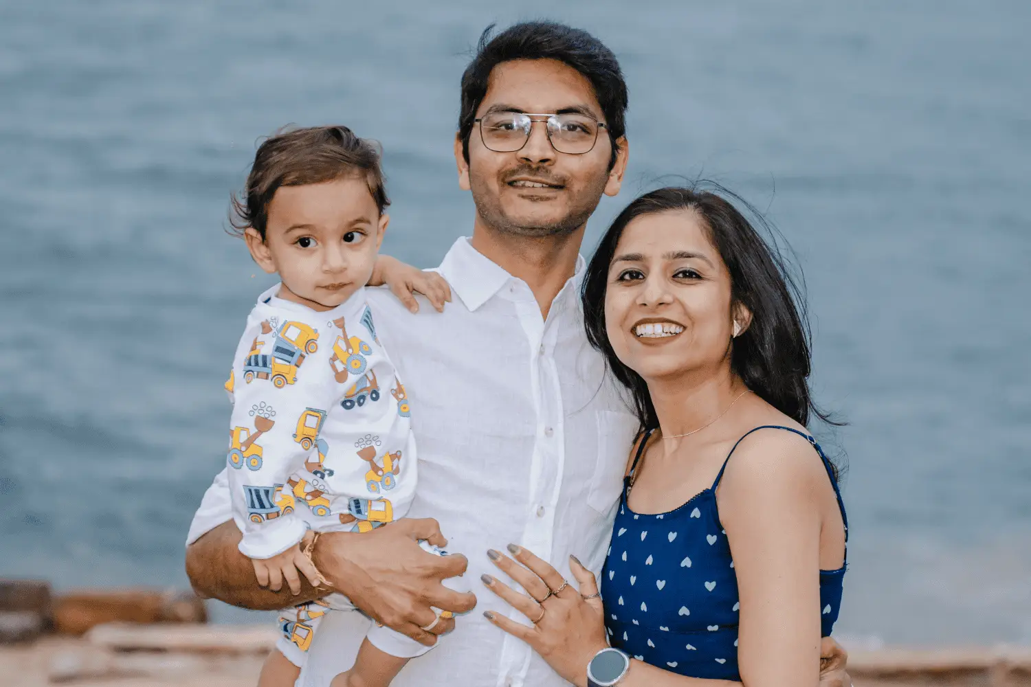 Happy family enjoying a day at the beach with their child, capturing magical family moments.