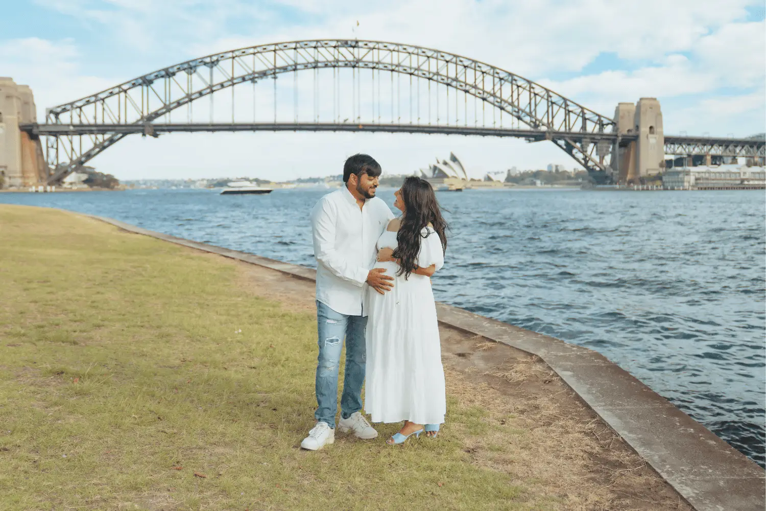 Romantic couple enjoying a magical moment by the water with Sydney Harbour Bridge in the background.