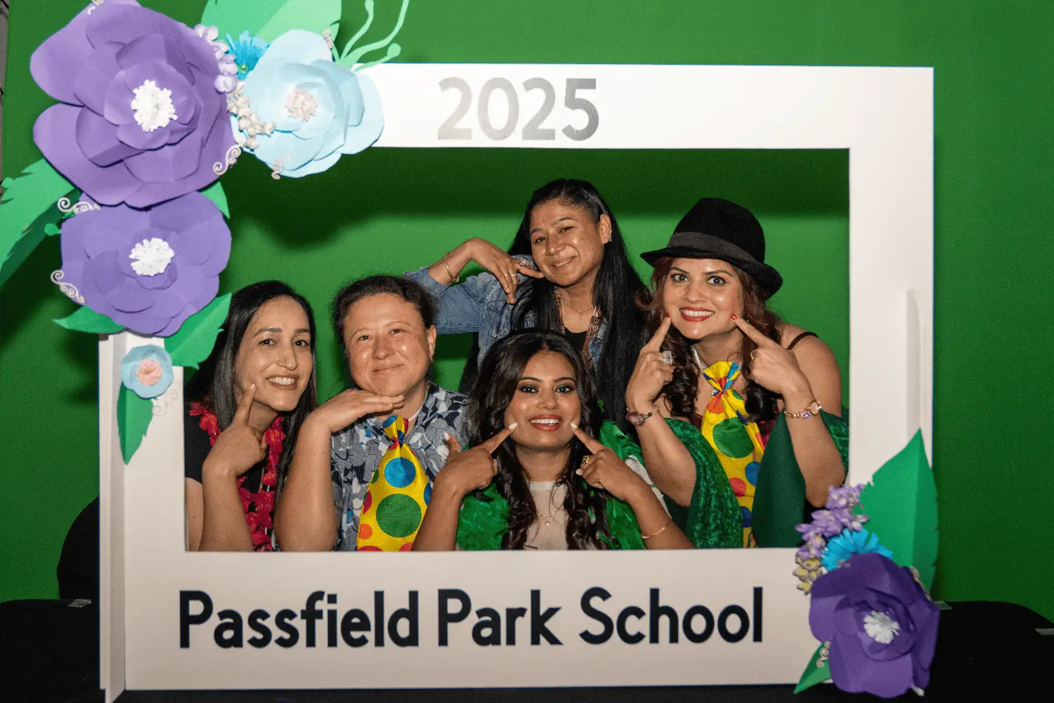 Group of joyful students celebrating graduation at Passfield Park School, 2025.